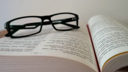 eyeglasses on an open book